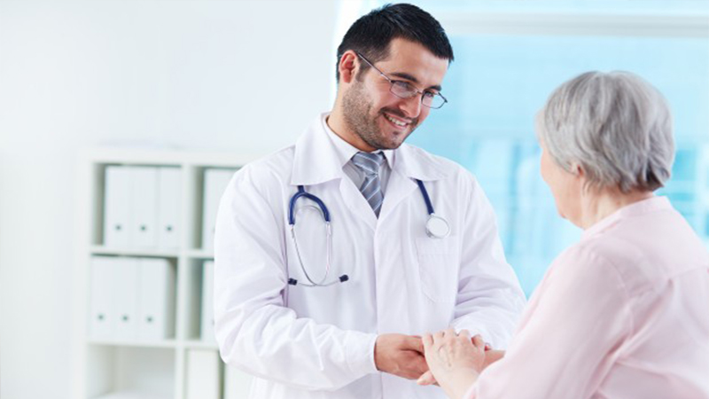 young-doctor-supporting-his-patient_1098-2237